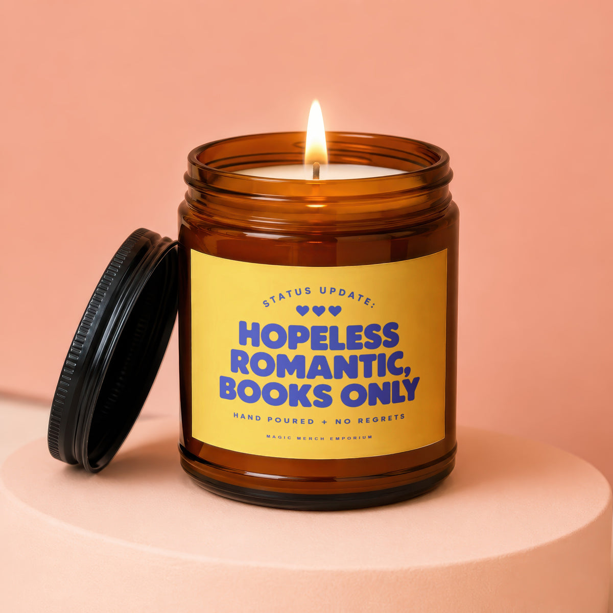 Amber jar candle with yellow label reading "Hopeless Romantic, Books Only"