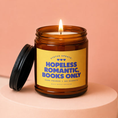 Amber jar candle with yellow label reading "Hopeless Romantic, Books Only"