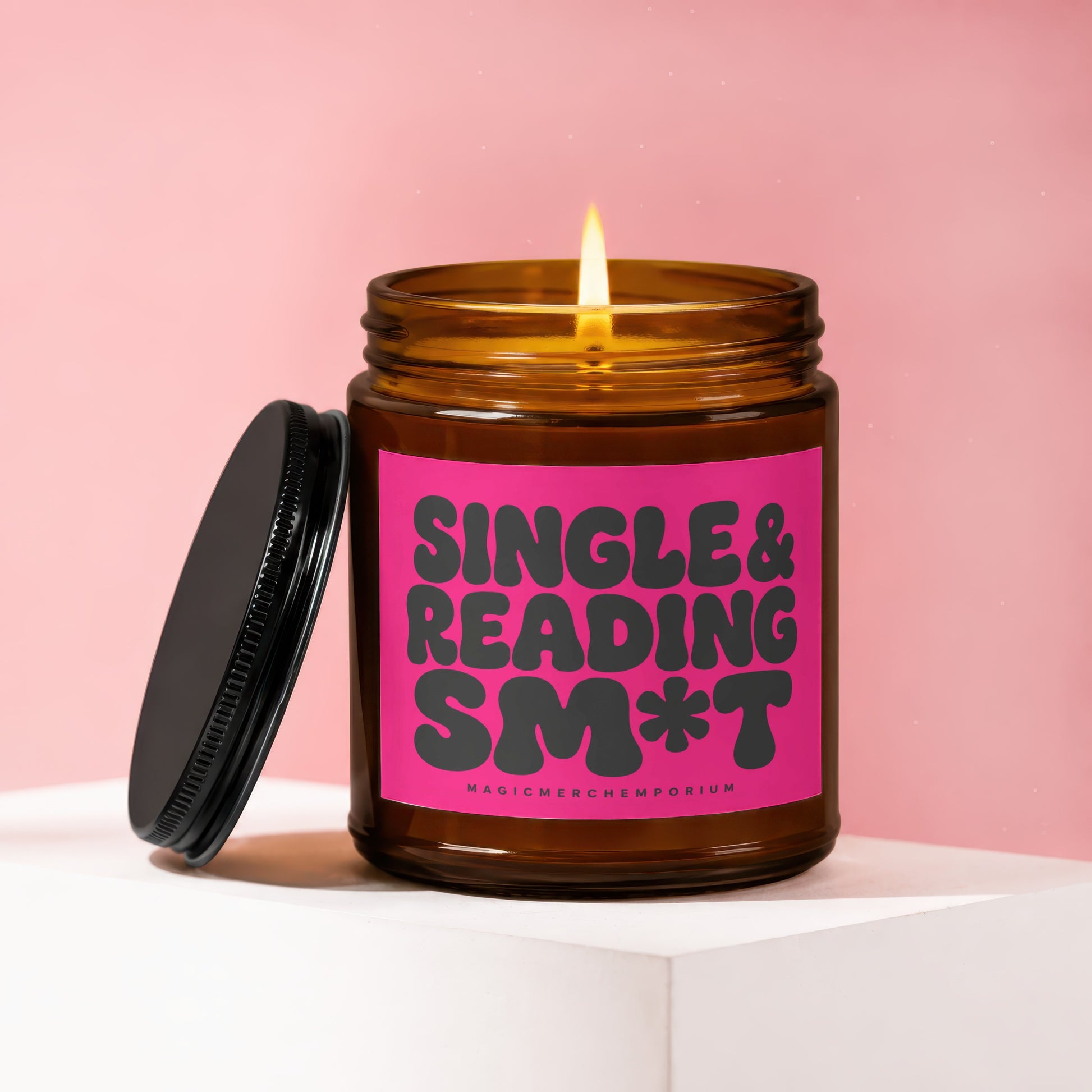 Candle with pink label that says "SINGLE & READING SM*T"