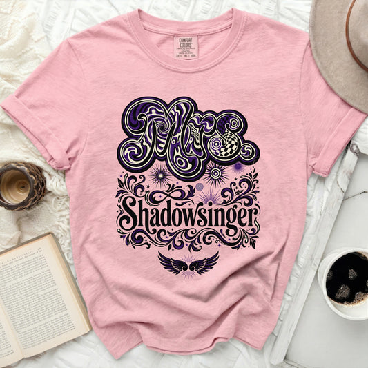 Pink t-shirt with "Shadowsinger" in ornate, decorative lettering.
