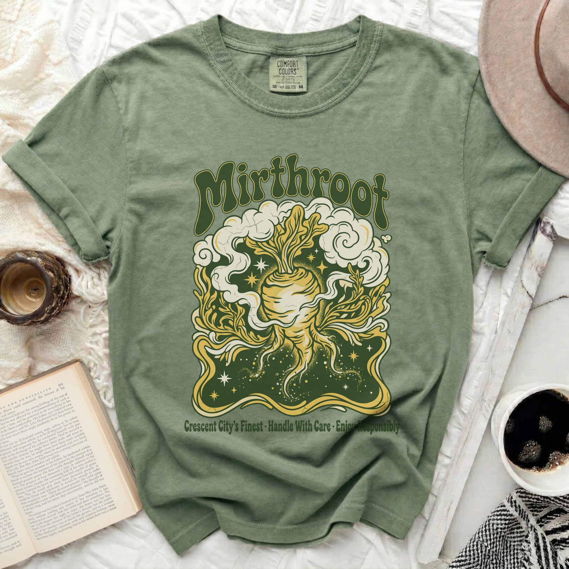 Green t-shirt with "Mirthroot" and a root vegetable design.