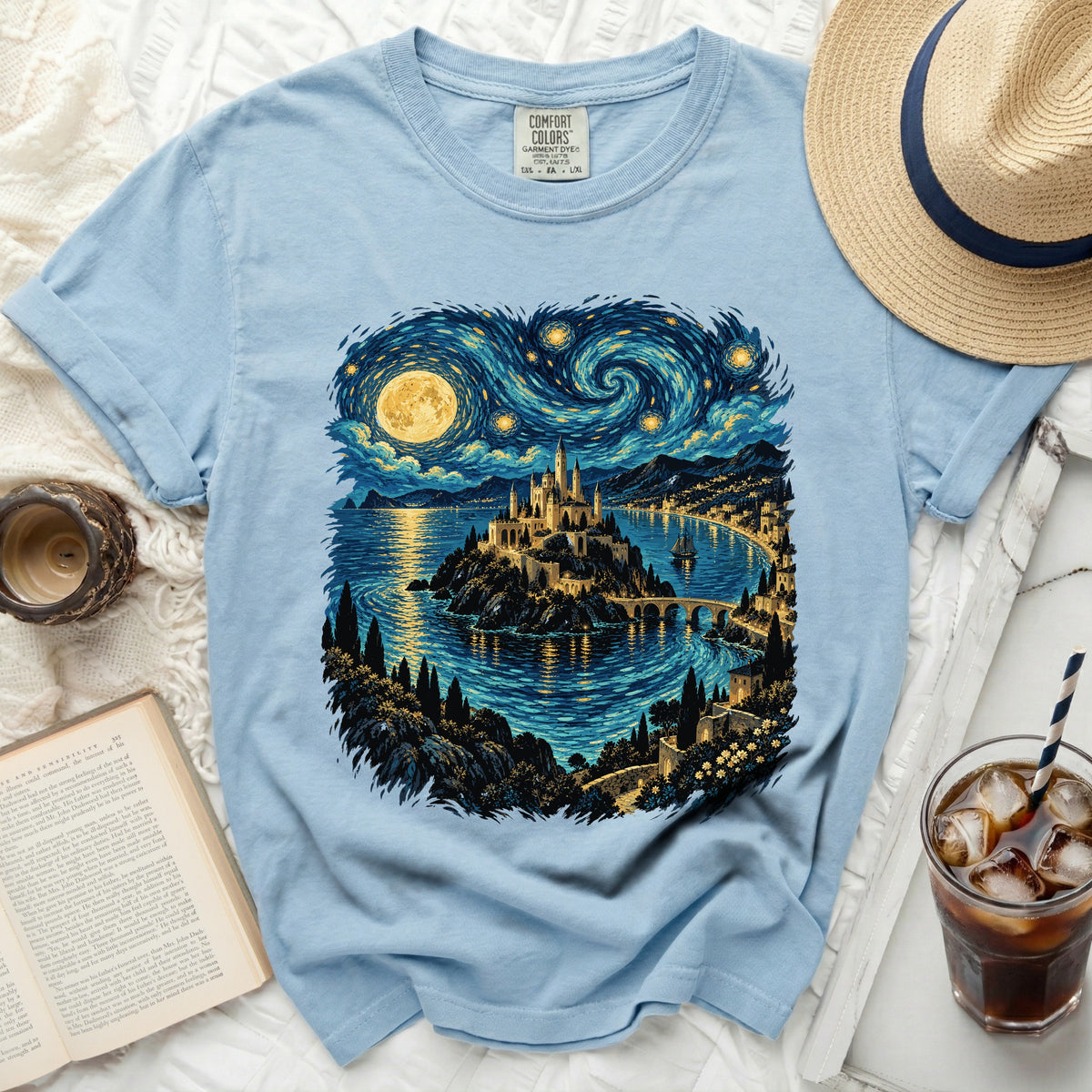 Light blue t-shirt with castle and starry night landscape print.