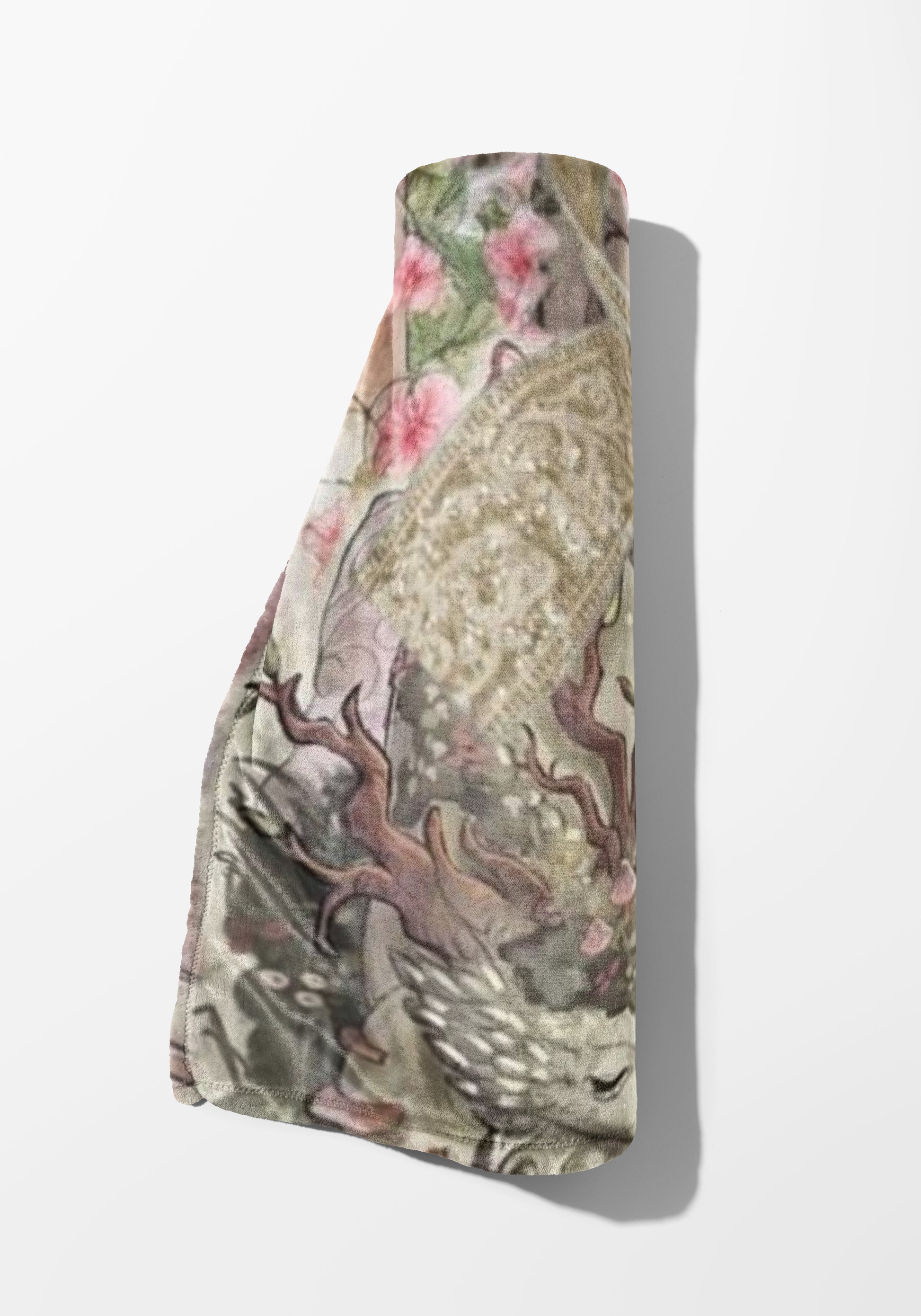 Rolled blanket with a detailed floral and vine design in muted, earthy tones.