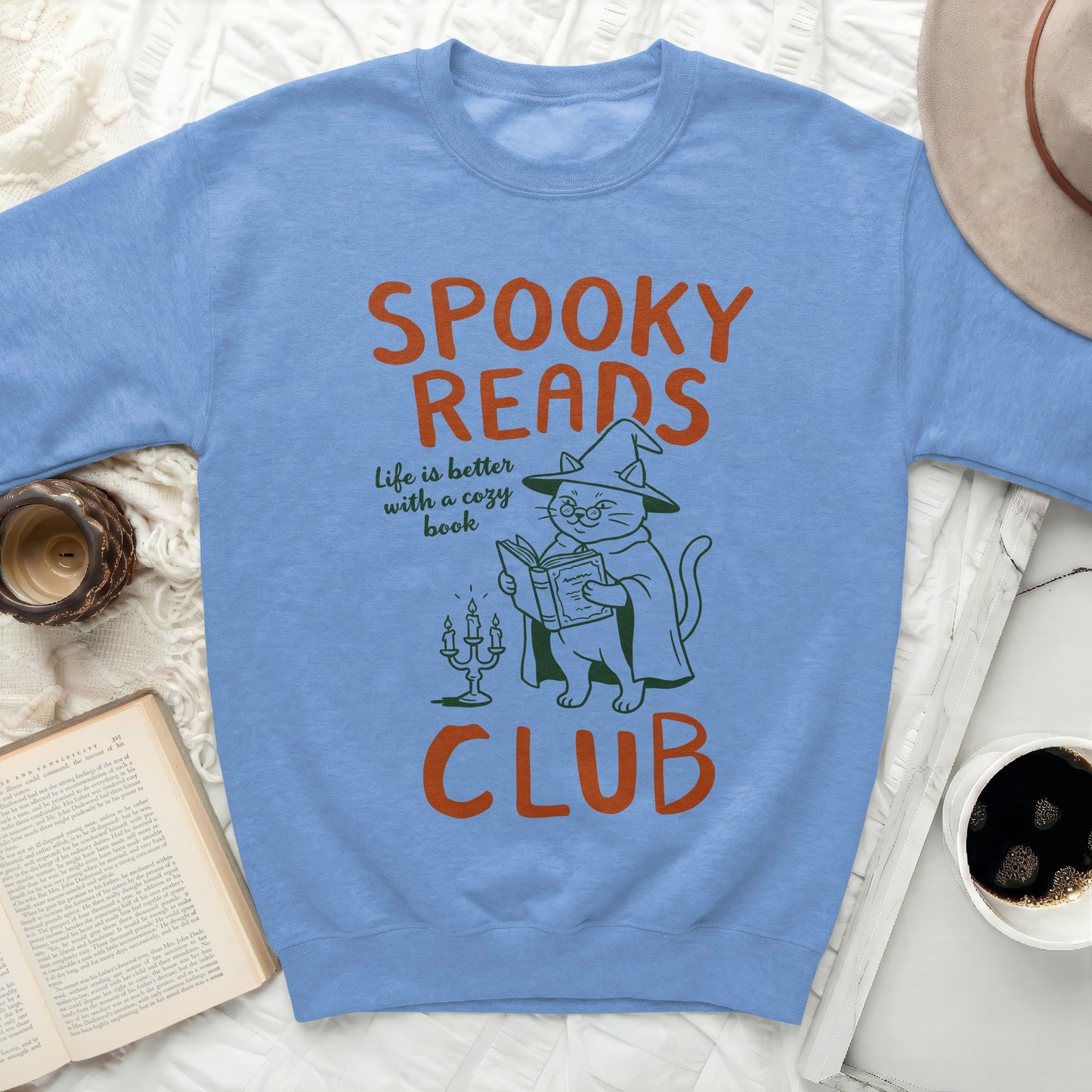 Light blue sweatshirt with "SPOOKY READS CLUB" and a witch cat.