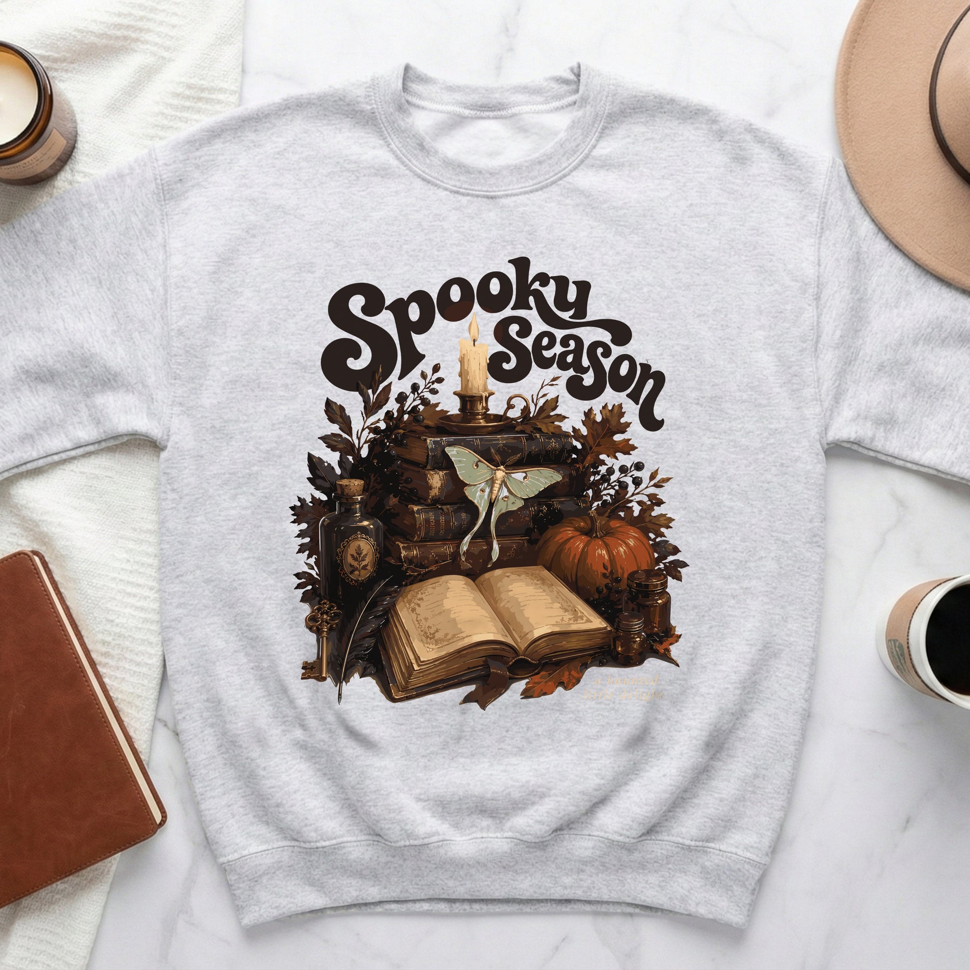 Grey sweatshirt with "Spooky Season" text and Halloween-themed illustration.
