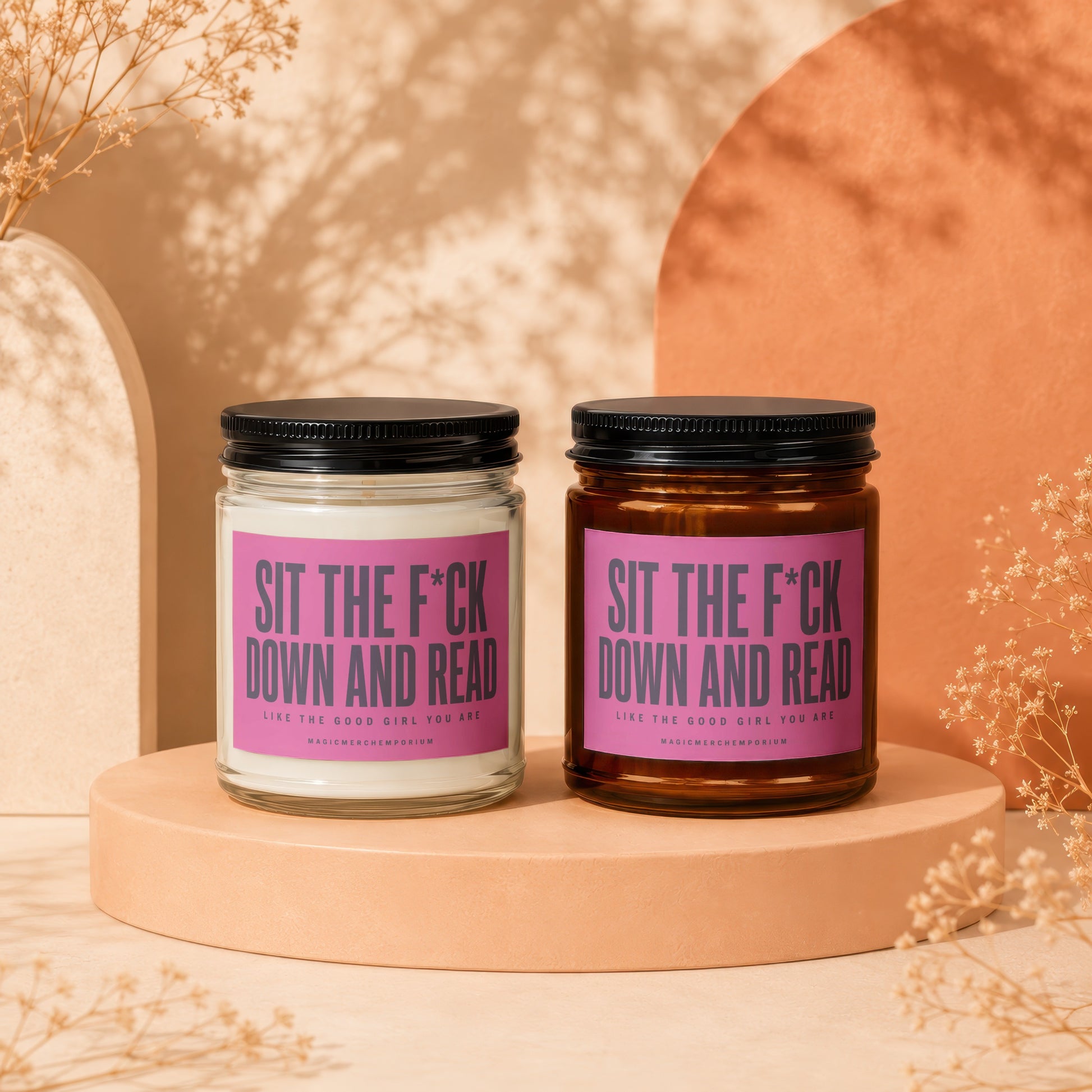 Two candles on display, both labeled "Sit the F*ck Down and Read."