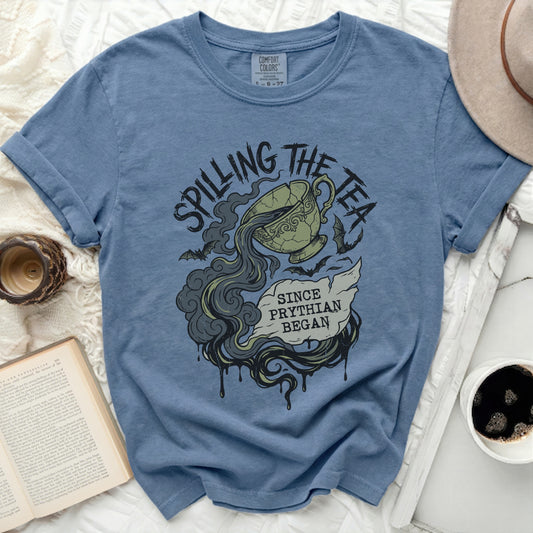 Blue t-shirt with "Spilling the Tea Since Pythian Began" graphic.