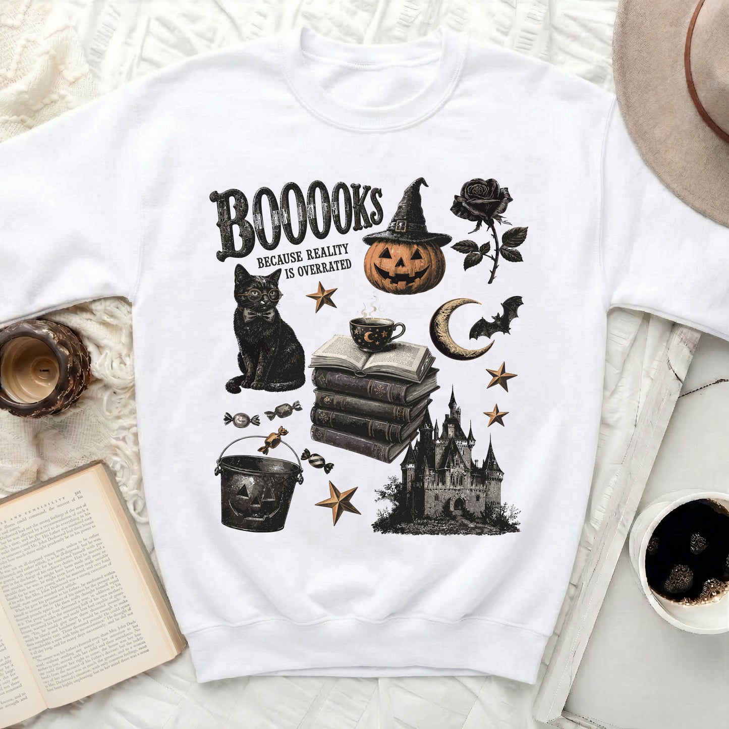 White sweatshirt with Halloween-themed "BOOOOKS BECAUSE REALITY IS OVERRATED" graphic.