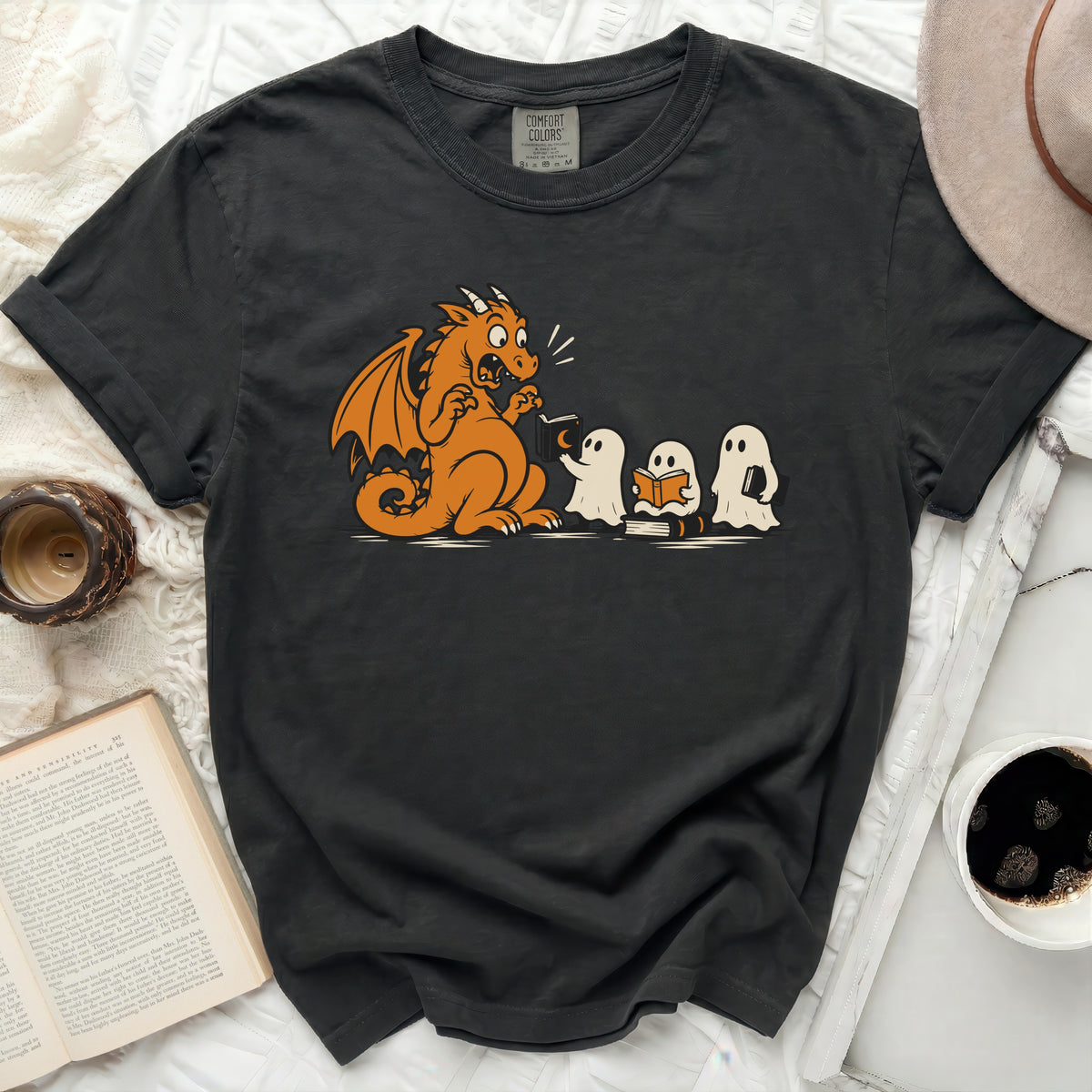 Black t-shirt with cartoon dragon and ghosts reading books graphic.