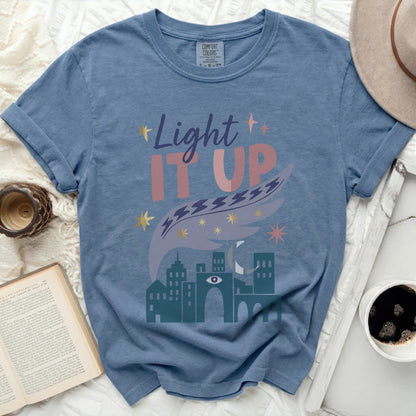 Blue t-shirt with "Light It UP" graphic featuring celestial and city elements.