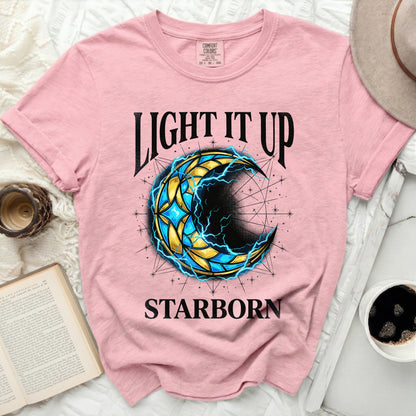 Pink t-shirt with a celestial crescent moon graphic and "Light It Up Starborn" text.
