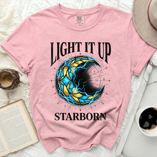 Pink t-shirt with a celestial crescent moon graphic and "Light It Up Starborn" text.
