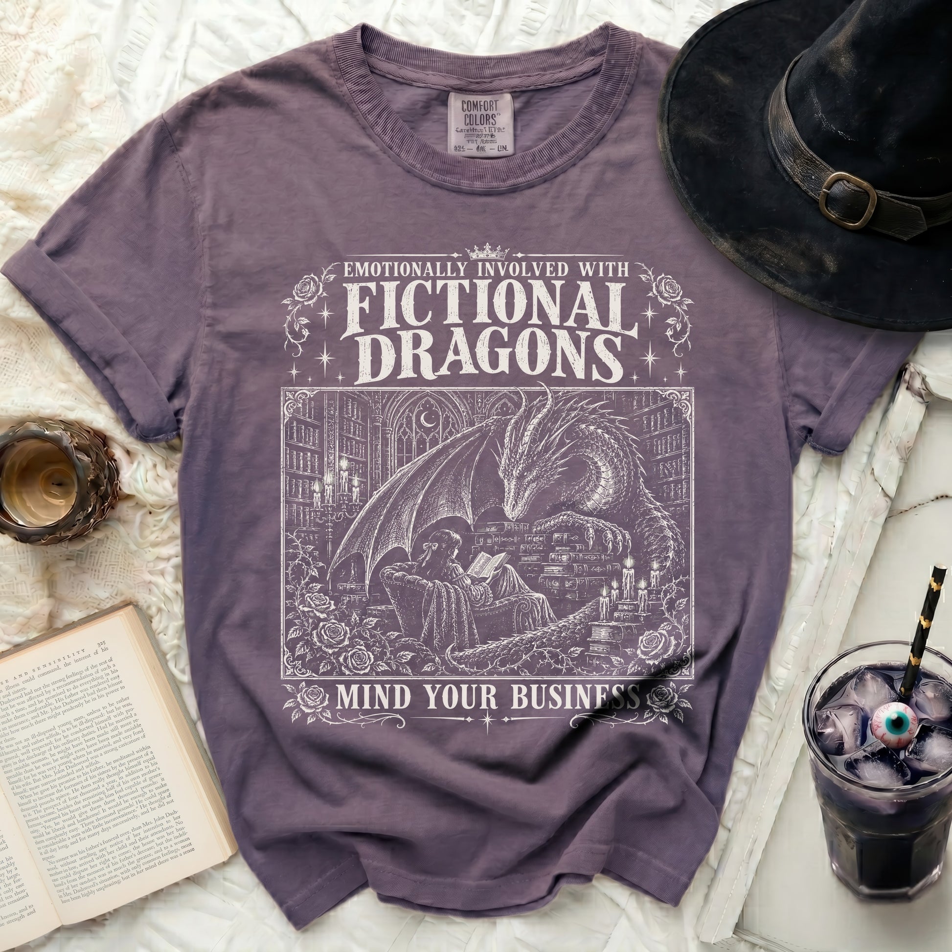 Purple t-shirt with white graphic text "Emotionally Involved With Fictional Dragons Mind Your Business."
