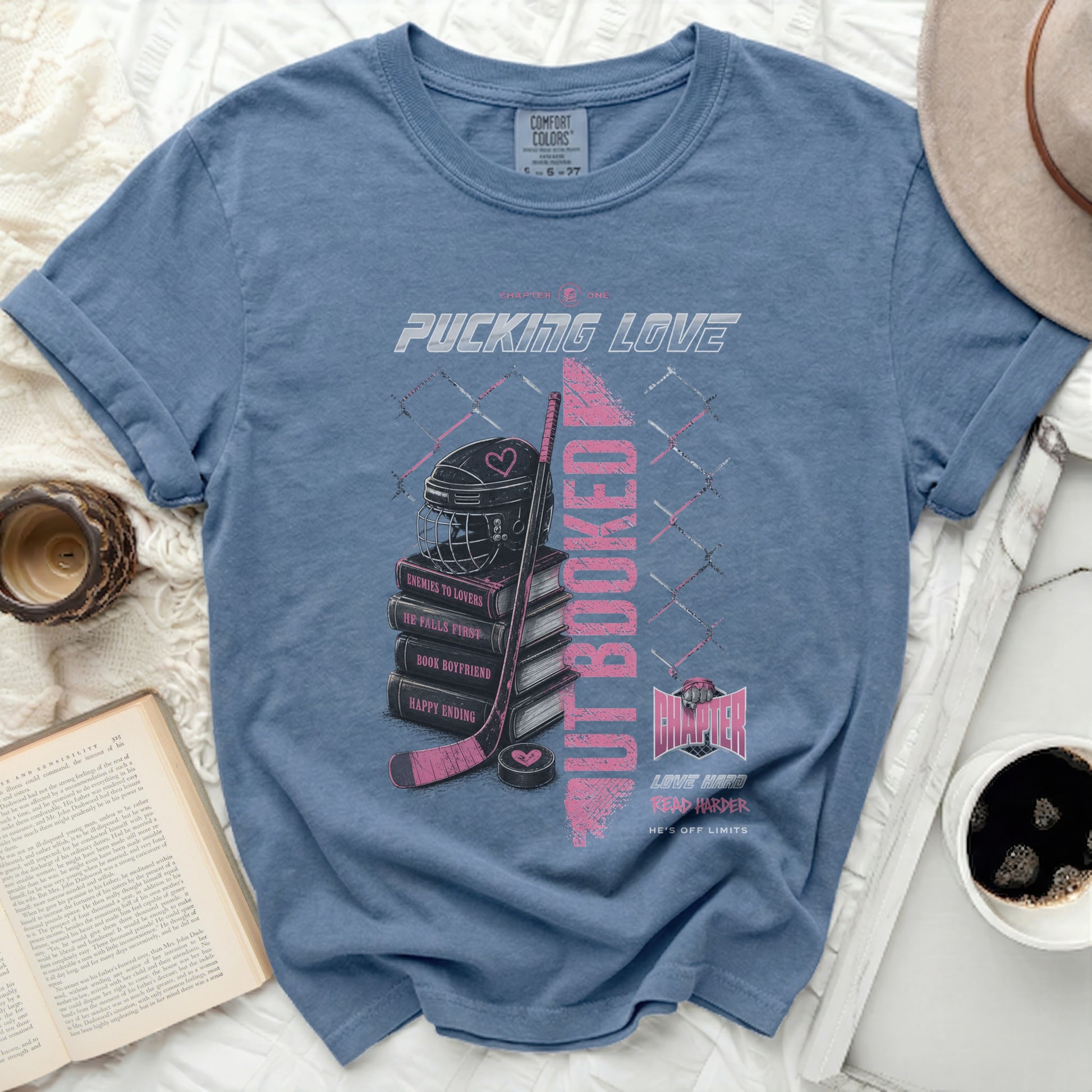 Blue t-shirt with hockey-themed graphic and text.