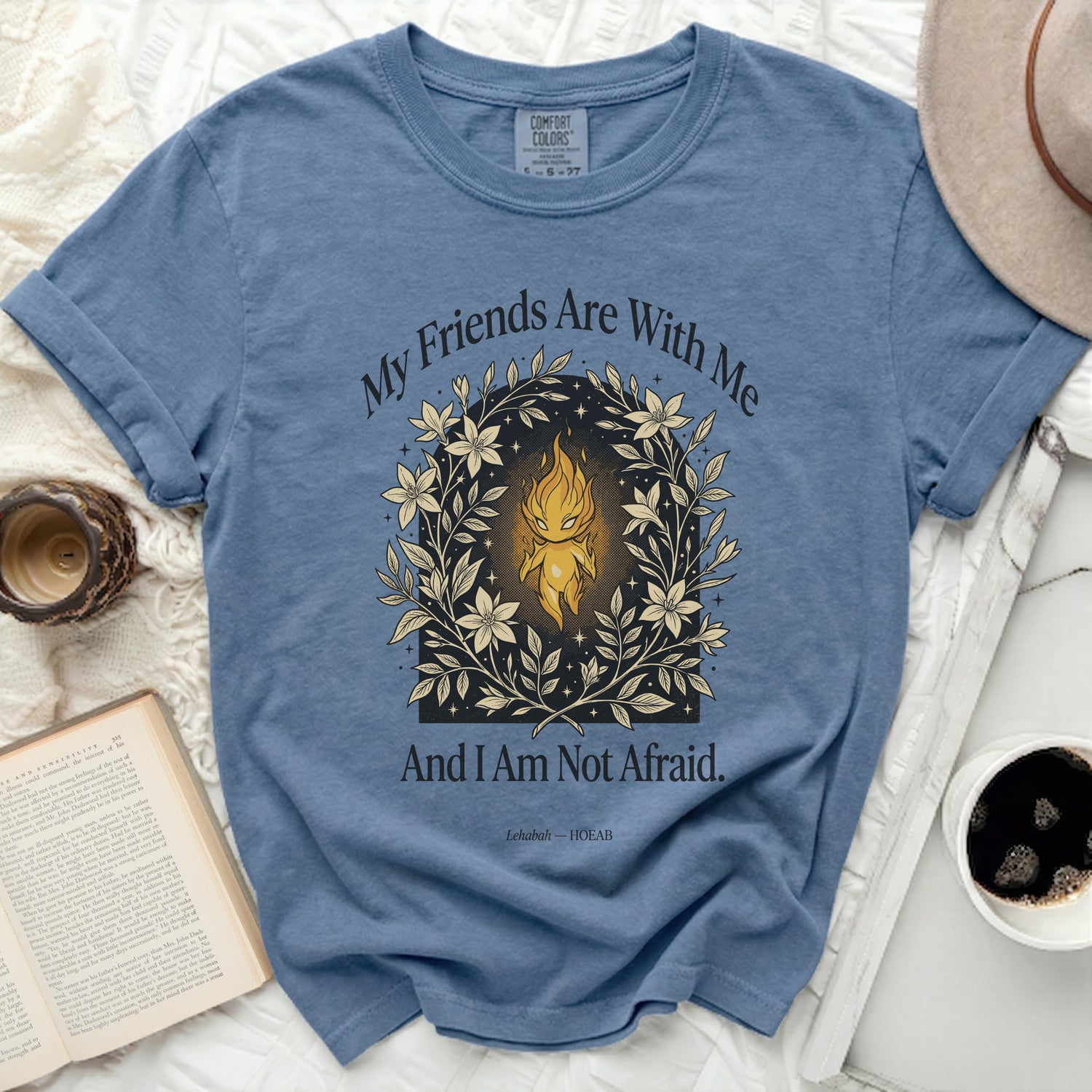Blue t-shirt with floral and flame graphic and "My Friends Are With Me And I Am Not Afraid." text.