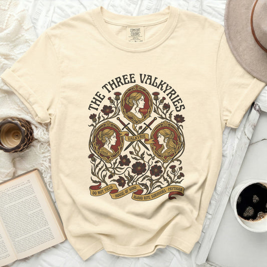 The Three Valkyries graphic on a cream Comfort Colors t-shirt.
