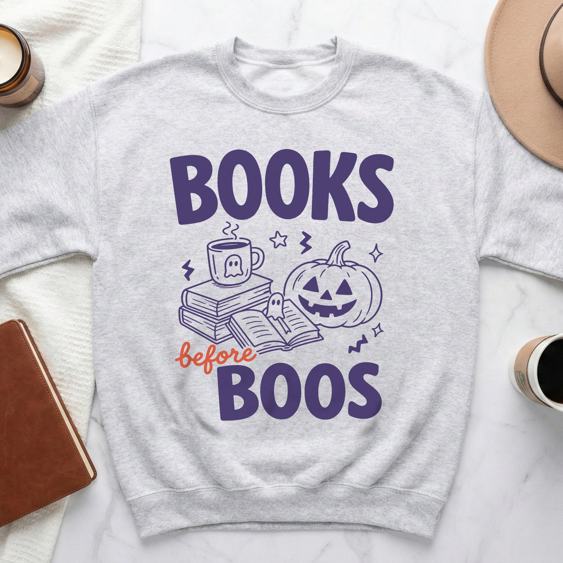Light gray sweatshirt with "Books before Boos" Halloween graphic featuring a pumpkin and coffee cup.