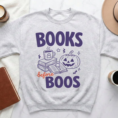 Light gray sweatshirt with "Books before Boos" Halloween graphic featuring a pumpkin and coffee cup.