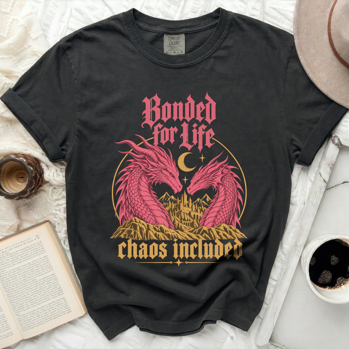 Black t-shirt with pink dragons, castle, moon, and text: Bonded for Life, Chaos Included.