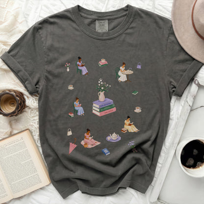 Dark t-shirt with illustrations of women reading books and drinking tea.