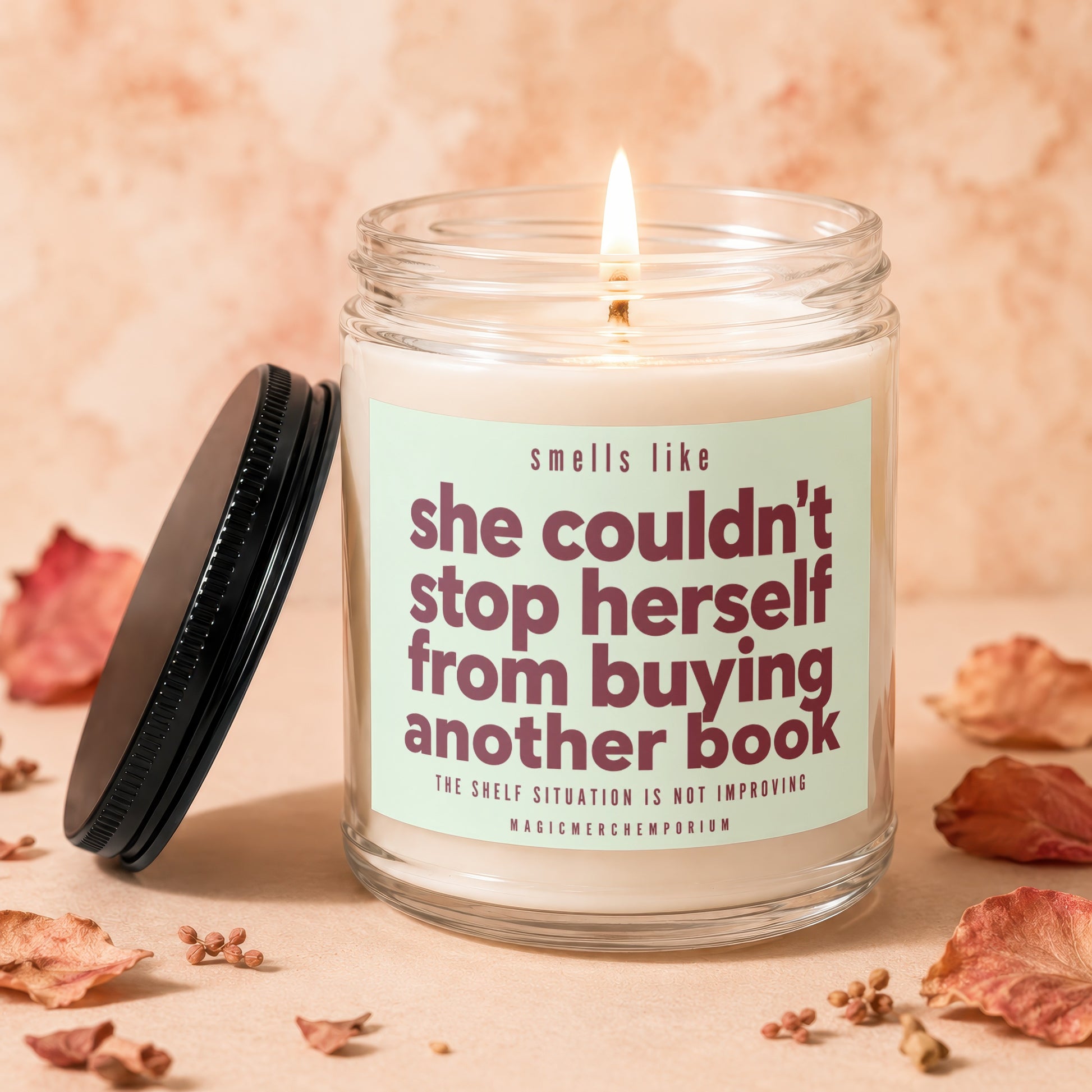 Candle with text "smells like she couldn't stop herself from buying another book."