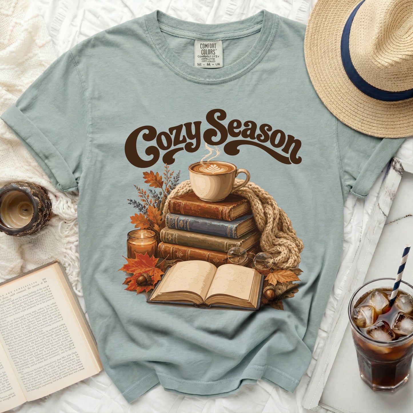 Dusty sage t-shirt with "Cozy Season" graphic and autumn scene.