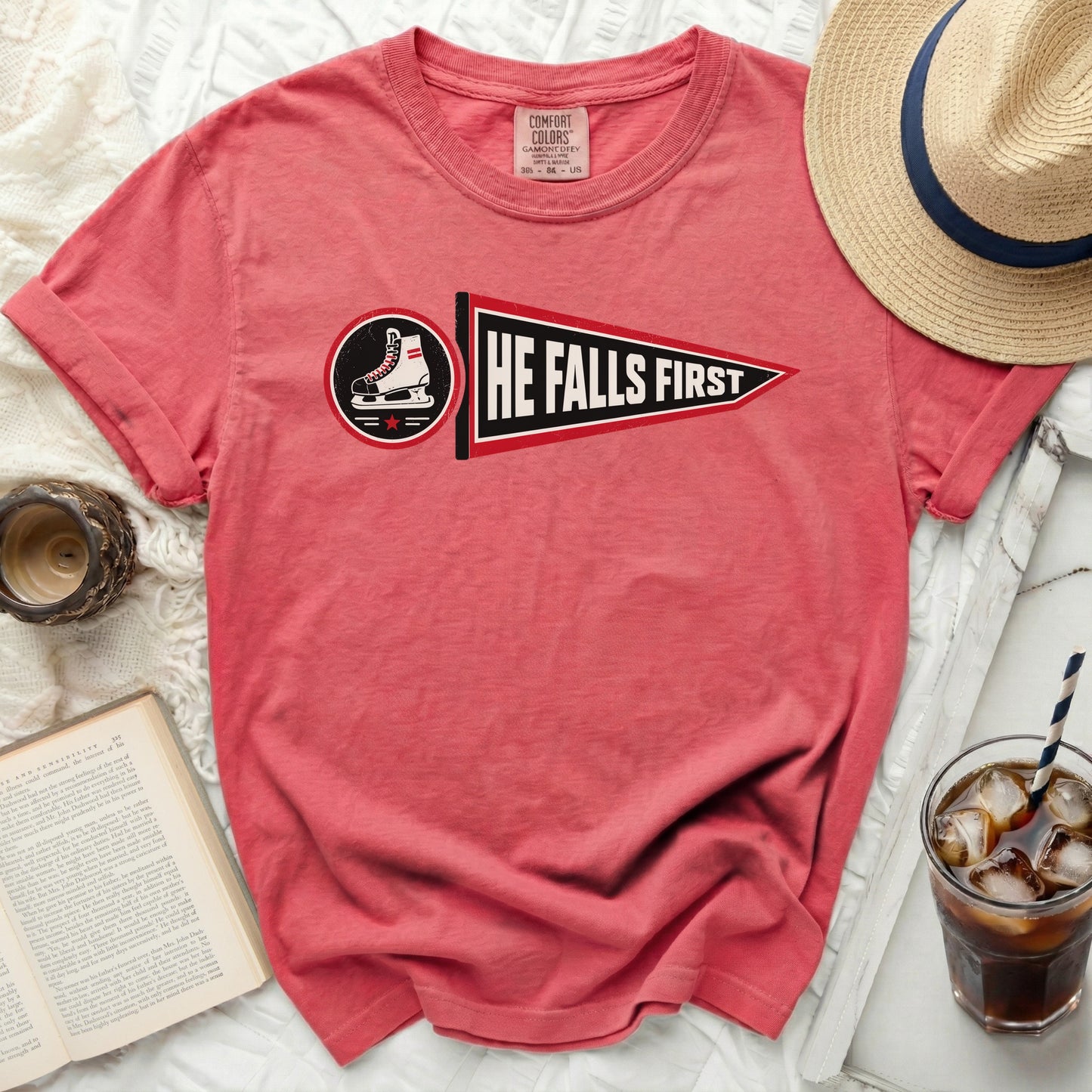 T-shirt with "HE FALLS FIRST" text and a hockey skate graphic.