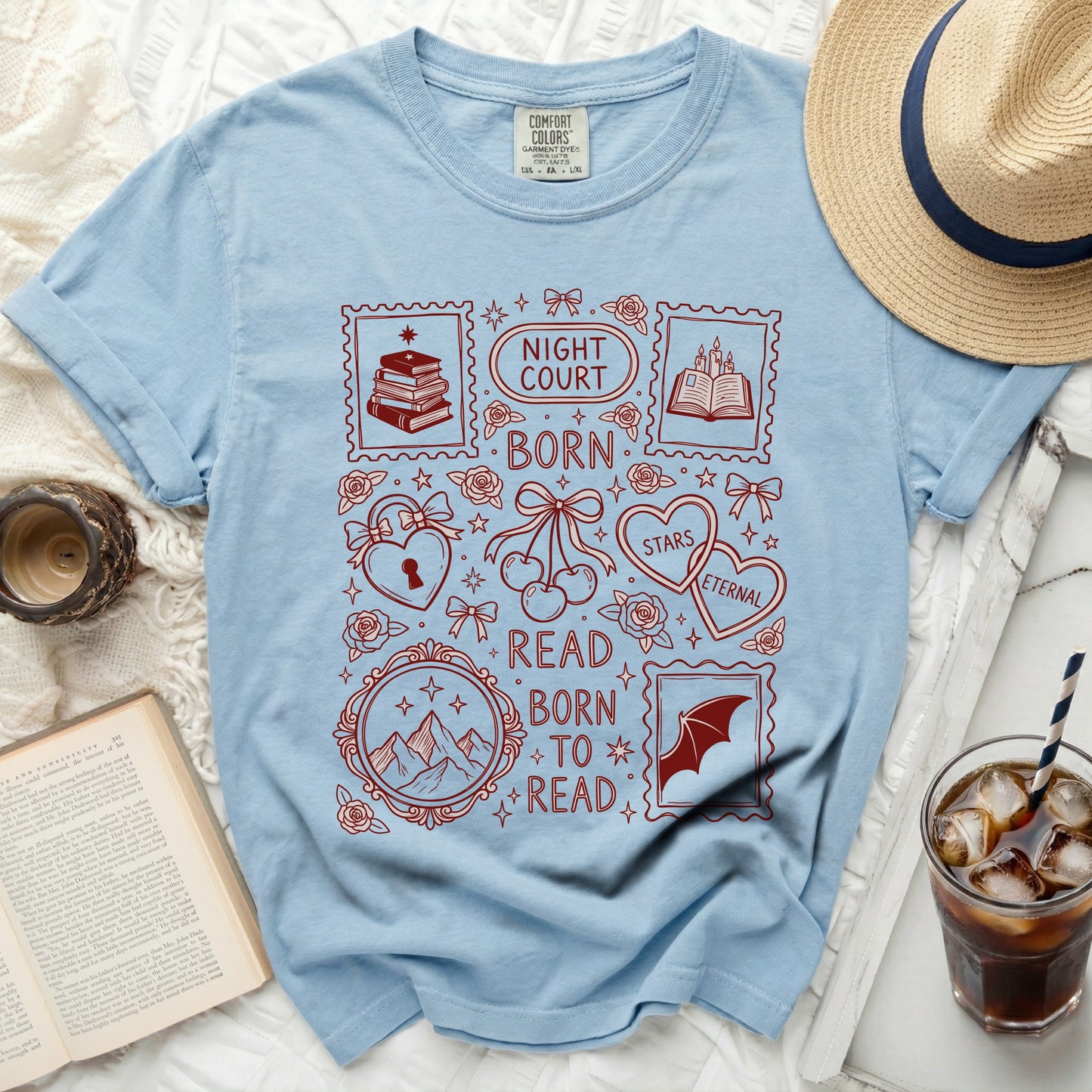 Light blue t-shirt with red "Night Court Born Read Born To Read" design and postage stamps.