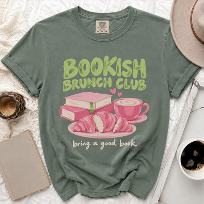 Green t-shirt with "Bookish Brunch Club" and "bring a good book" text, featuring books, croissants, and coffee.