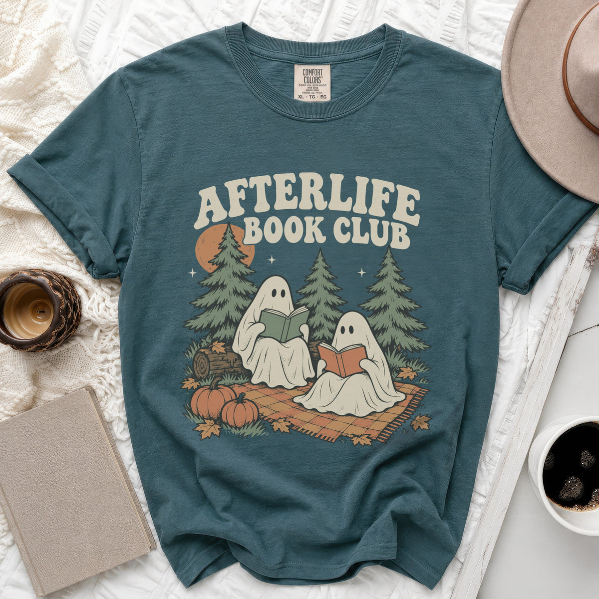 Teal t-shirt with "Afterlife Book Club" text and two ghosts reading.