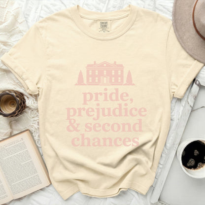 Cream t-shirt with light pink text "pride, prejudice & second chances" and a house graphic.