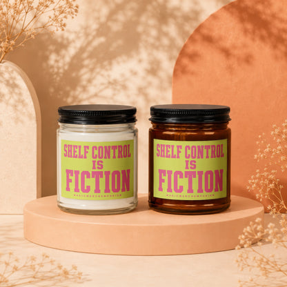 Two candles with "Shelf Control is Fiction" on green labels with pink lettering.