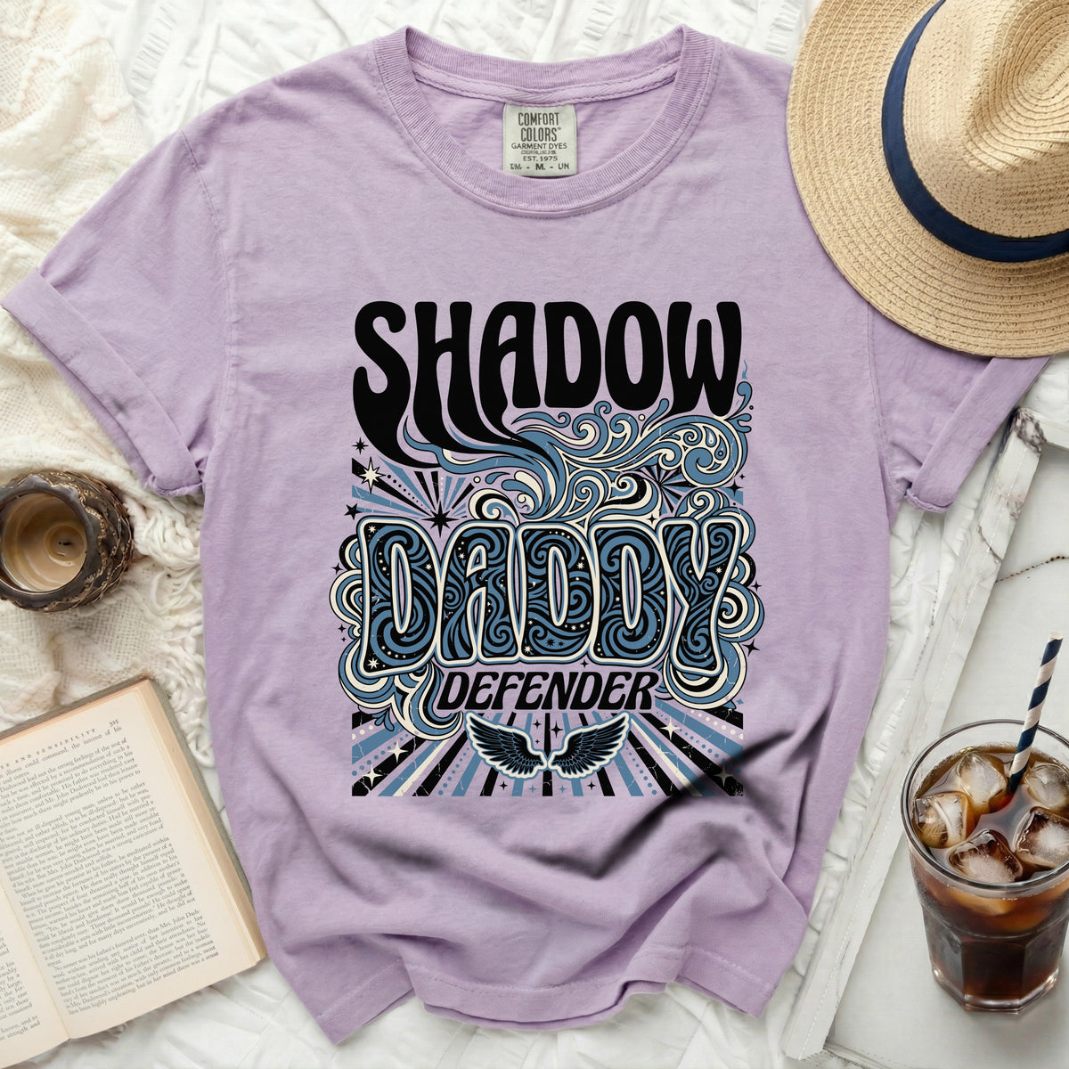 Lavender t-shirt with "Shadow Daddy Defender" graphic, wings, and stars.