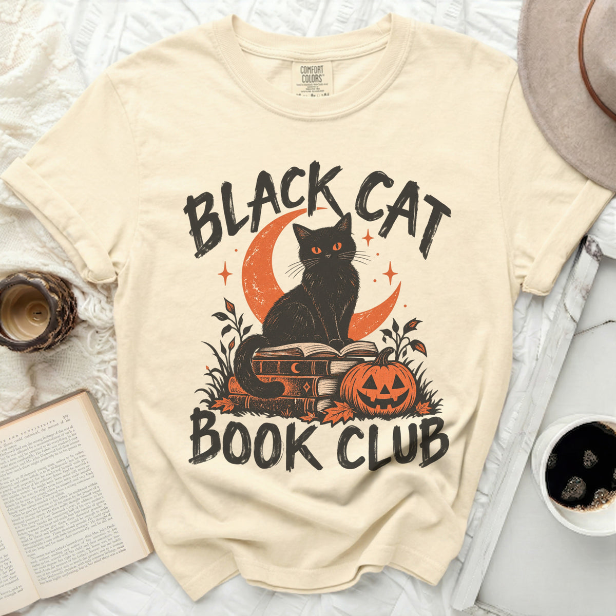 Black cat on books with pumpkin and text "BLACK CAT BOOK CLUB."
