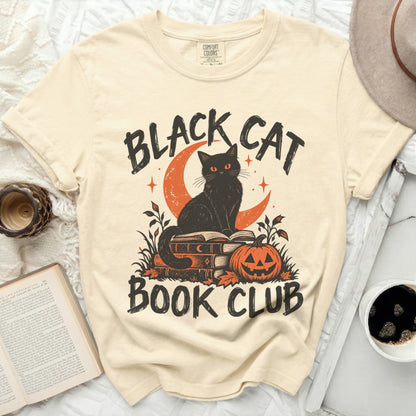 Black cat on books with pumpkin and text "BLACK CAT BOOK CLUB."
