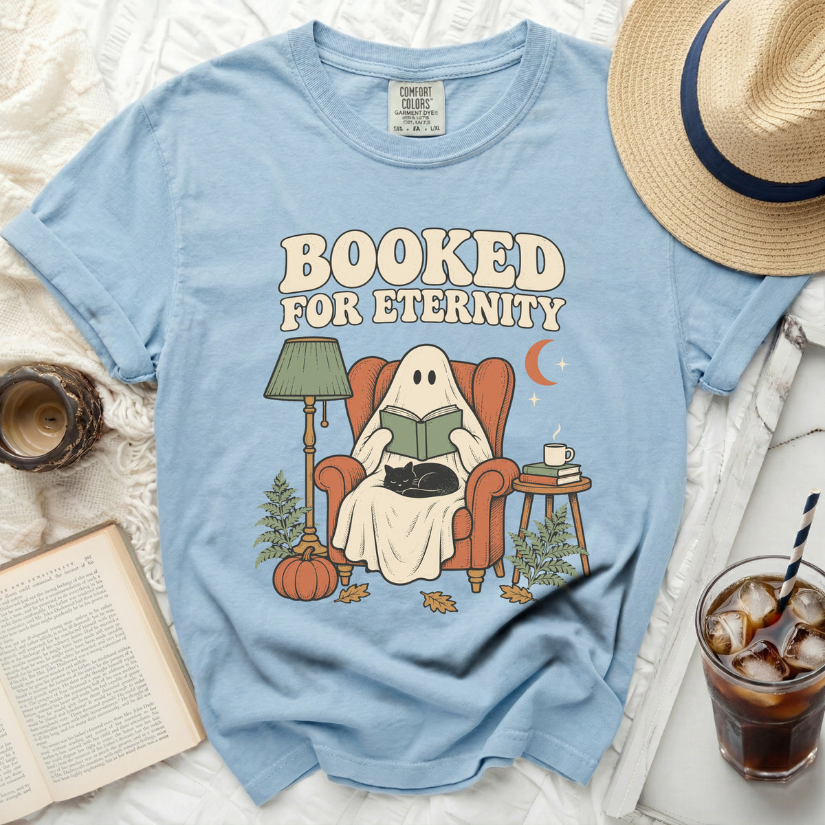 Light blue t-shirt with ghost reading a book and "Booked For Eternity" text.