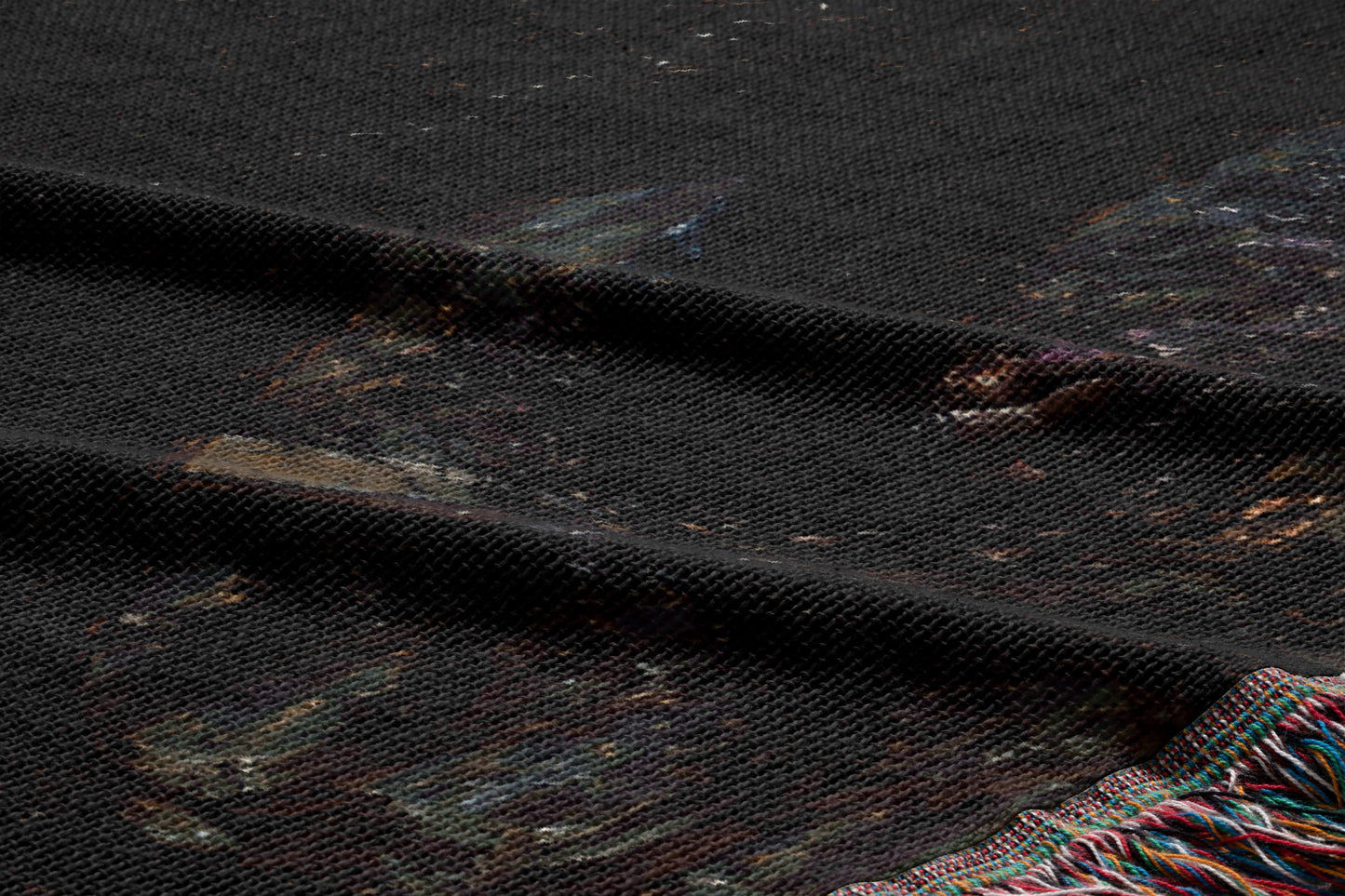 a close-up view of a dark fabric with a patterned design, featuring a mix of dark and lighter colors.
