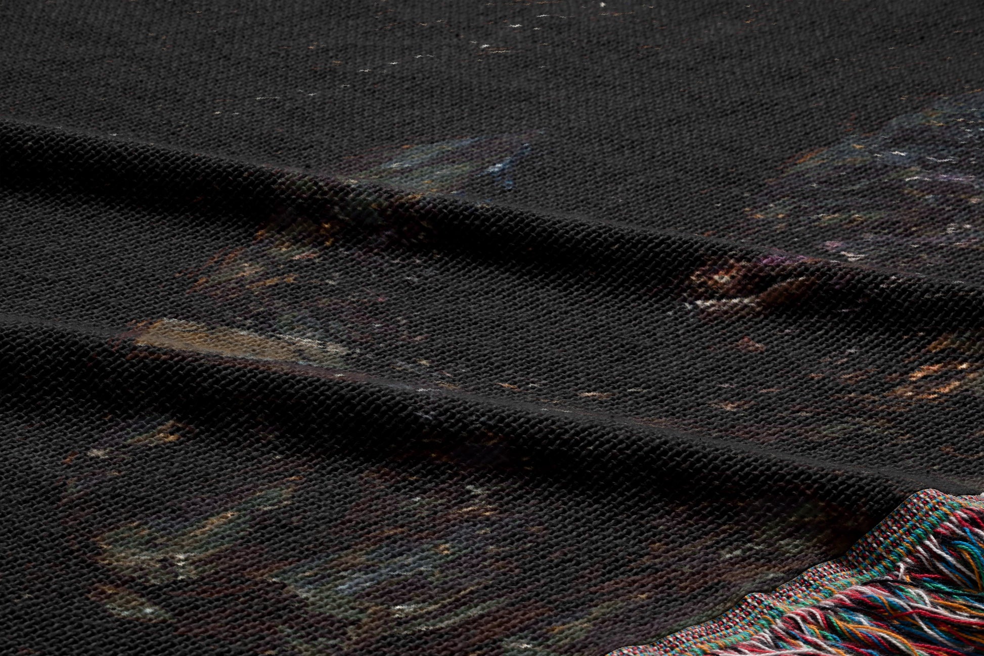 a close-up view of a dark fabric with a patterned design, featuring a mix of dark and lighter colors.