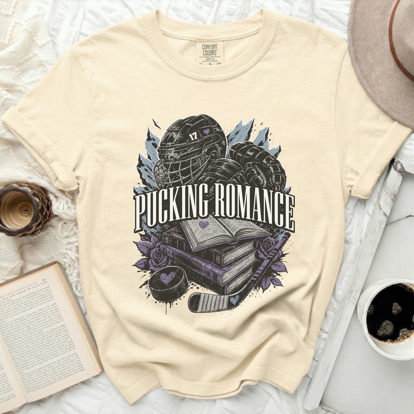 Cream t-shirt with "Pucking Romance" text and hockey graphics.