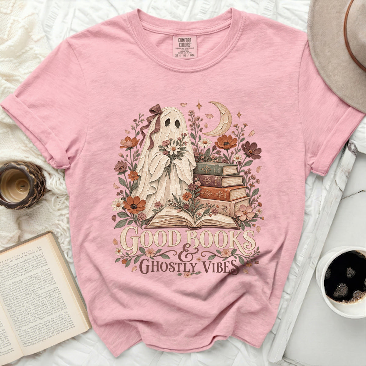 Pink t-shirt with ghost holding flowers, books, moon, and text "Good Books & Ghostly Vibes".