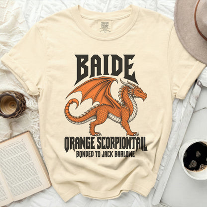 Cream t-shirt with an orange dragon graphic and text "BAIDE ORANGE SCORPIONTAIL BONDED TO JACK BARLOWE".