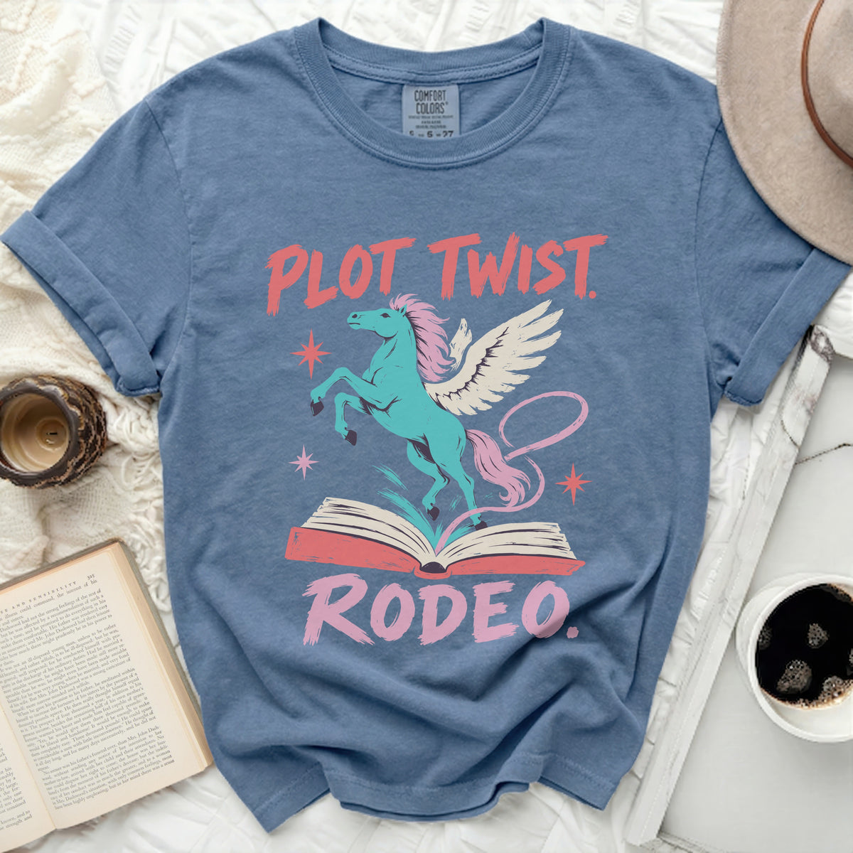 Teal winged horse jumping out of an open book with "PLOT TWIST RODEO" text.