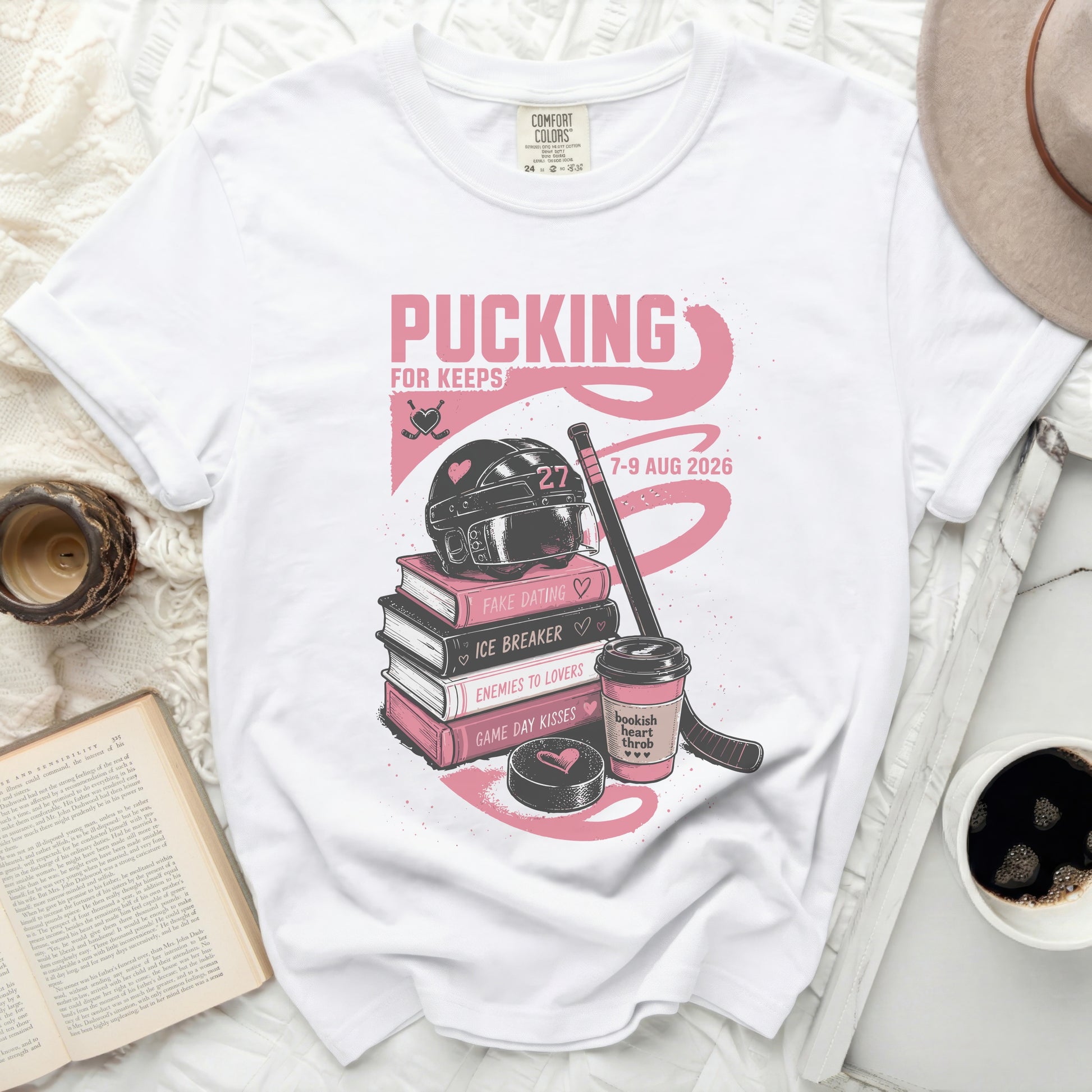 White t-shirt with "Pucking For Keeps" hockey graphic and event dates.