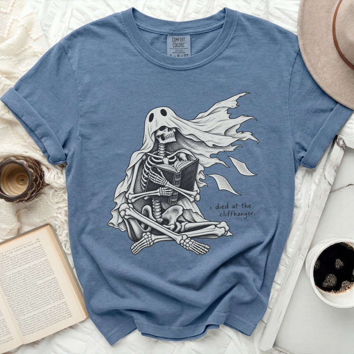 Skeleton ghost reading a book with text "i died at the cliffhanger."