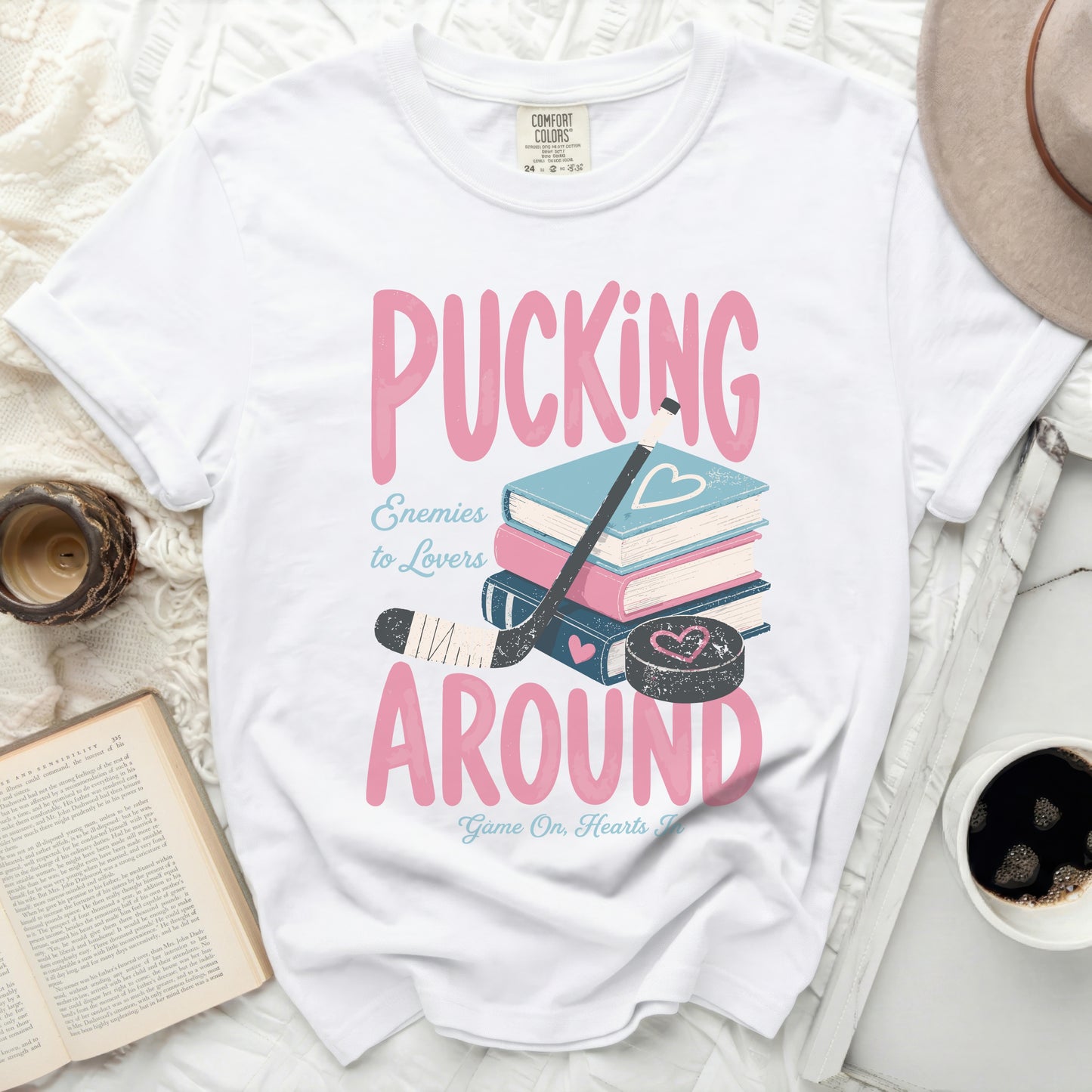 White t-shirt with "Pucking Around" text and hockey puck.
