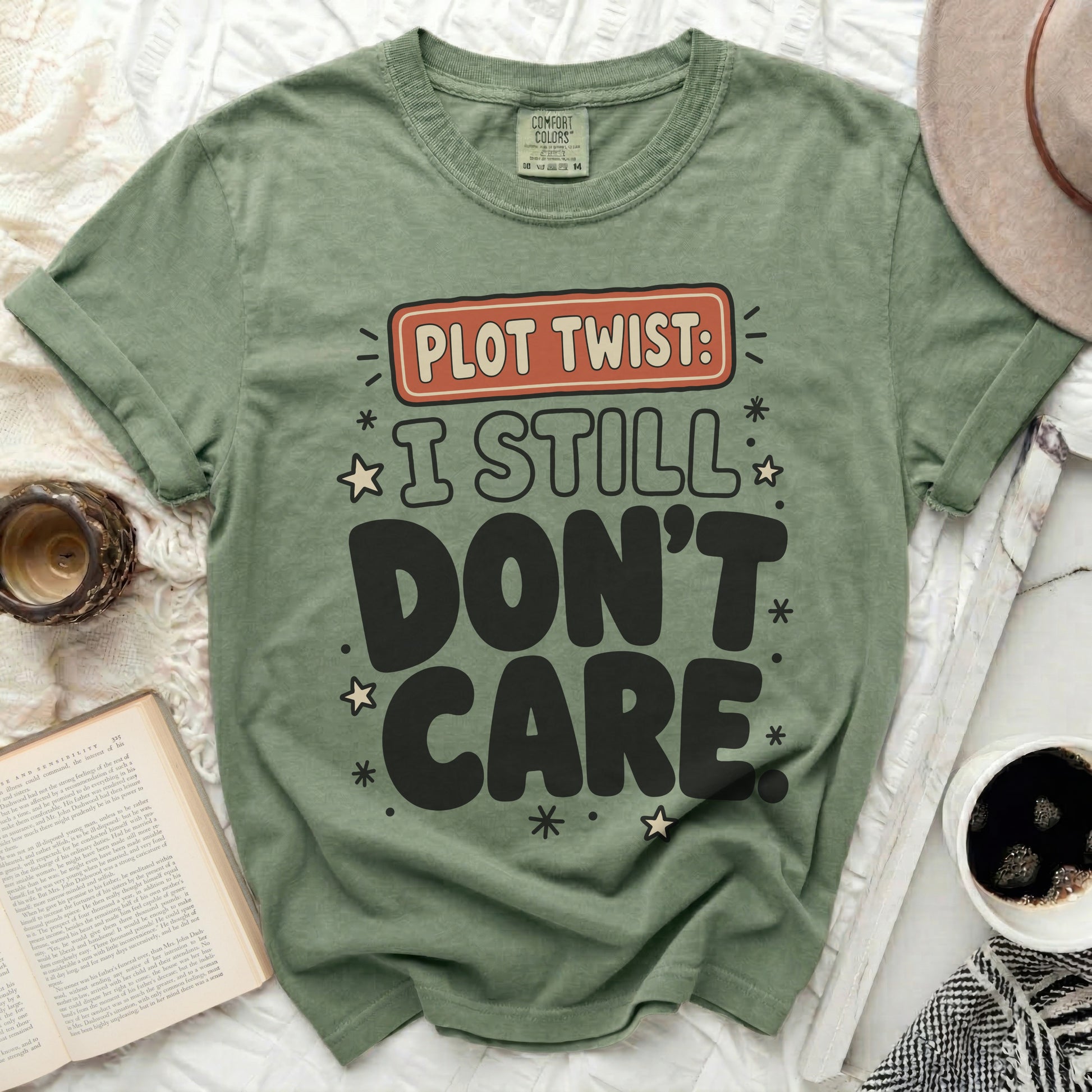 Green t-shirt with "Plot Twist: I Still Don't Care" graphic text.
