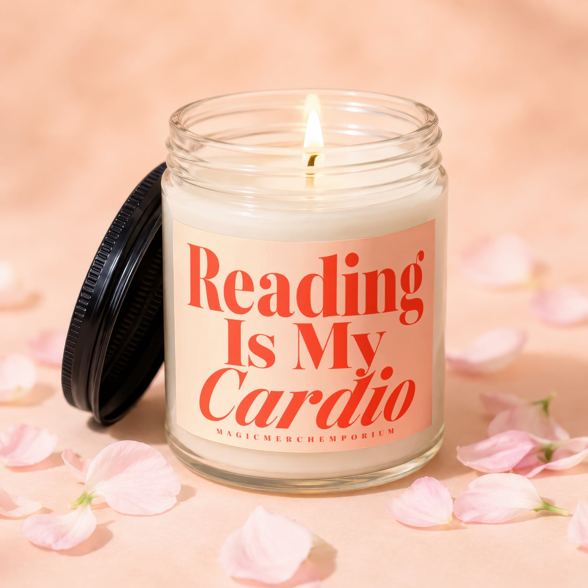 Glass candle with orange text "Reading Is My Cardio" on a pink label.