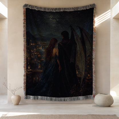 a large tapestry hanging on a wall, depicting a couple standing together under a starry night sky. The tapestry is framed by a decorative border and is surrounded by two small vases on either side.