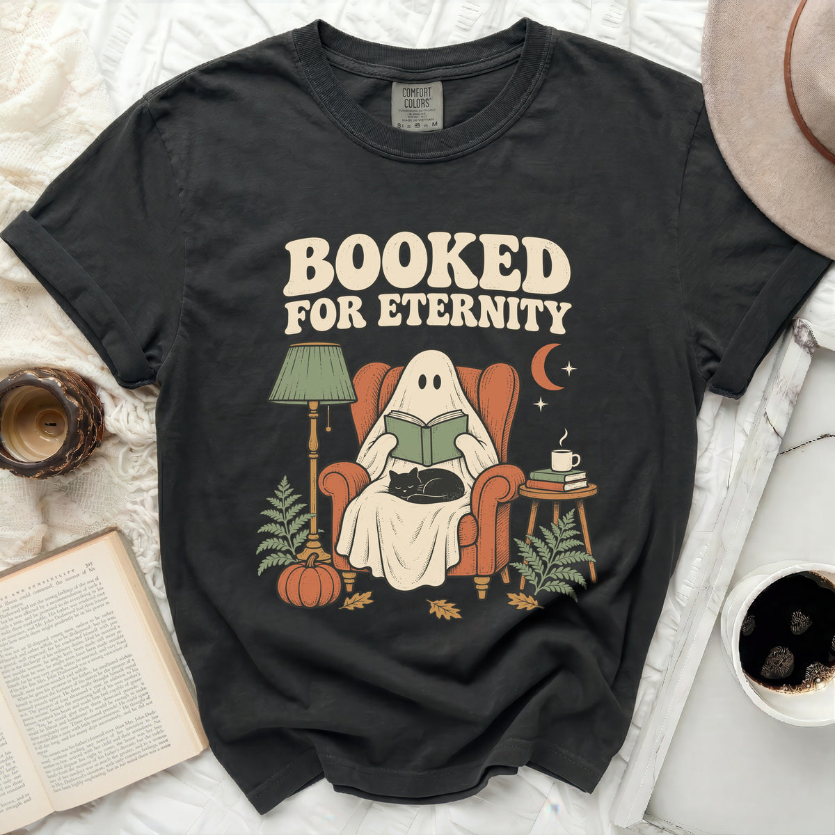 T-shirt with "Booked For Eternity" text featuring a ghost reading in a chair with a cat.