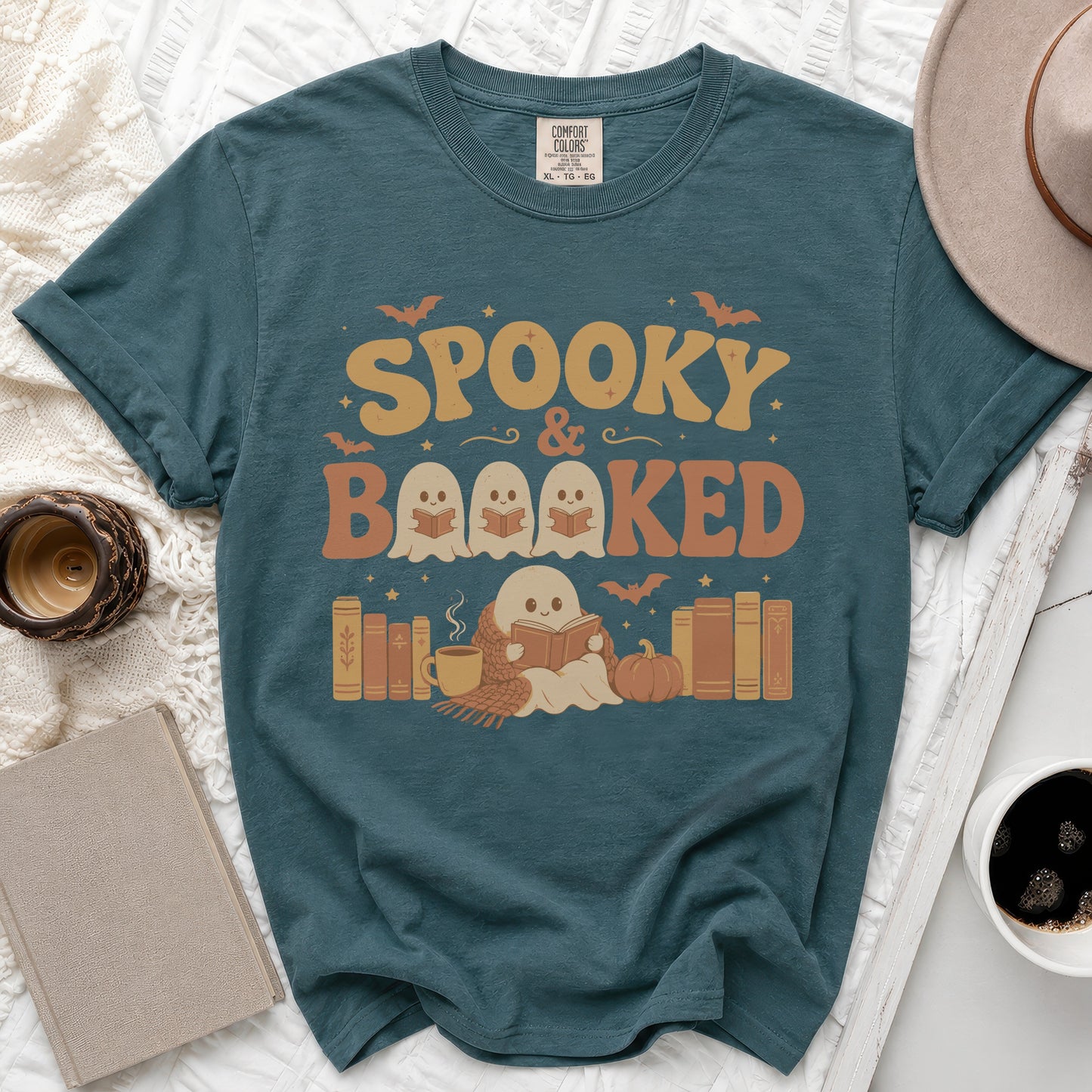 Teal t-shirt with "Spooky & Booked" text and ghosts reading books.